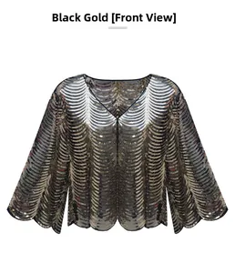Detail of elegant black gold sequin shrug with V-neck and flared mesh sleeves