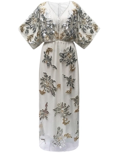 Detailed close-up of golden and silver sequin floral embroidery on a white mesh dress