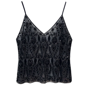 Close-up of black sequin camisole with detailed beadwork and vintage pattern