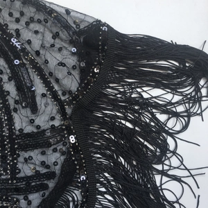 Detail of 1920s vintage black lace shawl with silver sequins and long fringe tassels