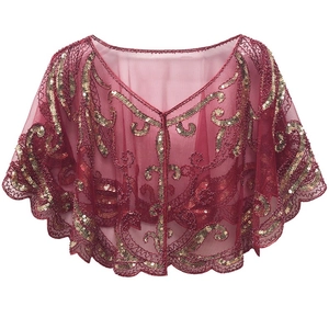 Detail of wine red mesh cape with gold sequin embroidery and scalloped lace trim