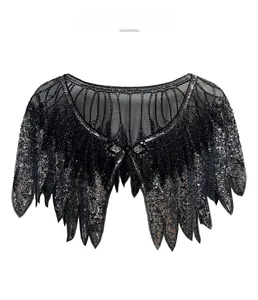 Detailed view of vintage black mesh capelet with silver sequin embroidery and bead trim