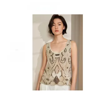 Close-up of sequined sleeveless top showing intricate gold beadwork and geometric patterns