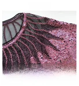 Detailed close-up of rainbow sequins on black sheer mesh shawl with fan patterns