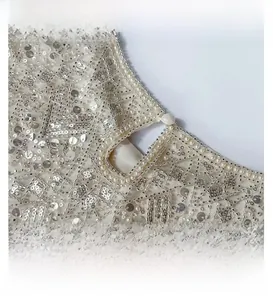 Detail of beaded neckline with silver sequins, faux pearls and teardrop cutout