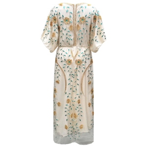 Detailed back view of white kaftan gown with intricate gold and cyan floral embroidery