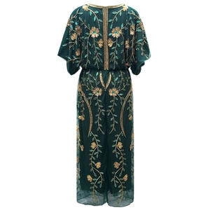 Detailed back view of dark green tulle dress with gold floral sequins and hidden zipper