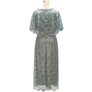 Detail of sequin embroidery and scalloped lace trim on back of sage green evening gown