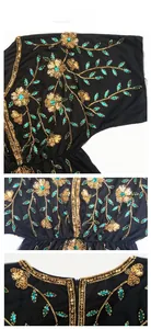 Detailed embroidery showing gold sequins and green beadwork on black mesh evening dress