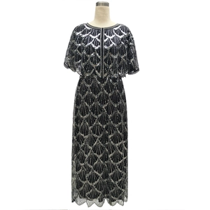 Detail of evening dress featuring silver sequins in geometric fan pattern on black mesh