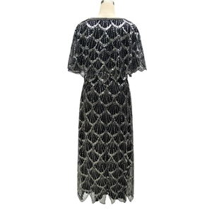 Detail of black evening gown featuring silver sequins in a vintage scalloped pattern