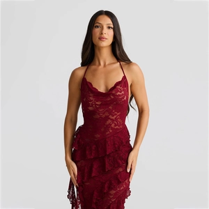 Detail view of burgundy floral lace fabric and elegant tiered ruffle hemline on dress