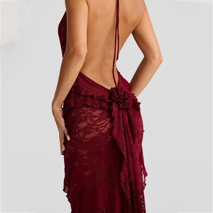 Detail of wine red lace dress featuring open back design and 3D fabric flower decor
