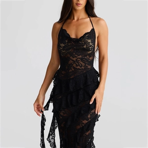 Detail of black lace halter dress with ruffled hem and delicate wave pattern fabric