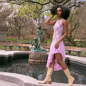 Detailed texture of purple lace sleeveless dress with high slit and layered hemline