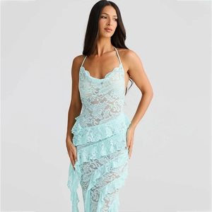 Detailed view of mint green lace dress with ruffled layers and delicate halter neck texture