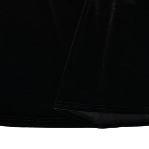 Detailed macro shot of black velvet fabric texture and professional double-stitch hem edge