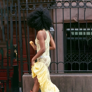 Detailed view of the yellow lace material and ruffled hemline on this summer dress