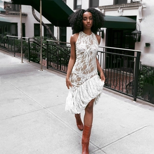 White lace halter dress with asymmetrical ruffled hem and sheer floral patterns