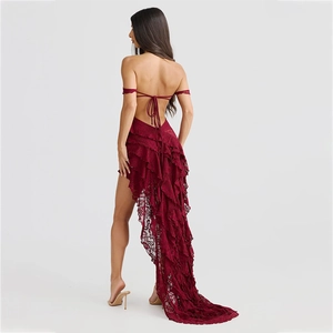 Detail of burgundy lace dress featuring backless tie design and asymmetrical ruffled hem
