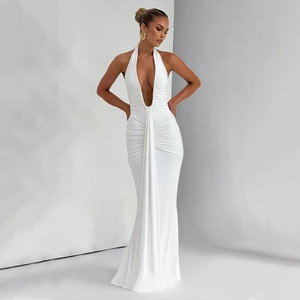 Close-up of elegant pleated details and deep V-neck on a white halter maxi dress