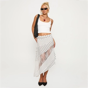 Detail of irregular polka dot skirt with floral lace panels and asymmetric hemline