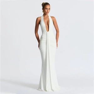 Detail of elegant white halter neck maxi dress with deep V-neck and ruched waist texture