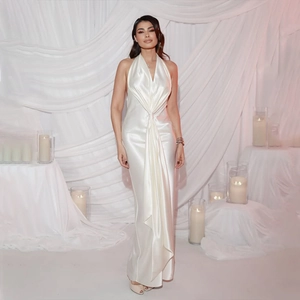 Detail of white satin halter maxi dress featuring a twisted knot and pleated neckline