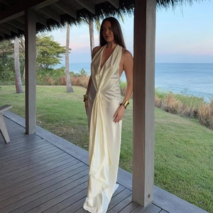Detailed view of the knotted waist and elegant draping on ivory satin halter dress