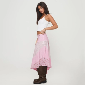 Detail of pink patchwork maxi skirt with irregular hem and floral polka dot patterns