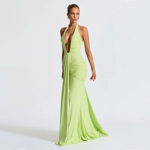 Detail of lime green halter neck maxi dress featuring deep V-neck and ruched fabric texture