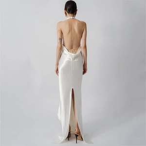 Detail of white satin dress featuring a low backless design and thin cross ties