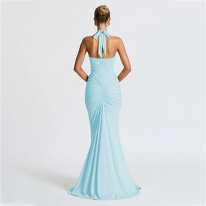 Detail view of the deep v backless design and ruched fishtail hem on light blue halter gown