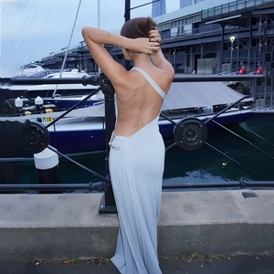 Back view of a sleek light blue backless dress with elegant ruching and knot details