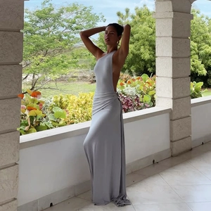 Detailed view of grey one-shoulder dress with elegant draping and pleated waist design