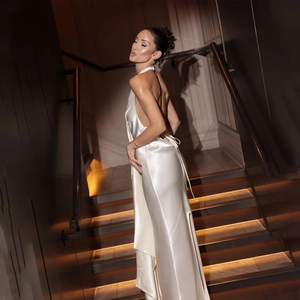 Elegant white satin halter neck backless evening dress with a high side slit design