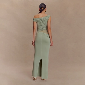 Back view of a sage green mesh maxi dress featuring a chic cutout waist and high slit detail