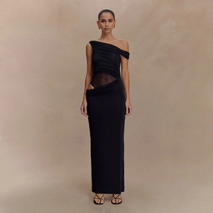 Detail of black asymmetrical cutout dress featuring sheer mesh paneling and slim fit