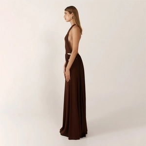 Detail of elegant dark brown backless evening gown with waist pleats and metal accent