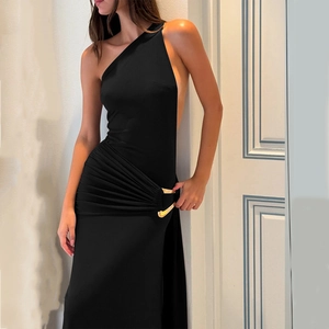 Detail of elegant black one-shoulder dress showing side pleats and golden metal ring accents