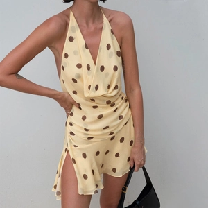 Detail of cowl neck and brown polka dots on yellow satin dress with side slit