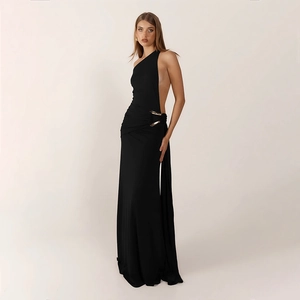 Detail of elegant black evening gown featuring a stylish gold buckle and side cut-out waist
