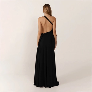 Elegant backless detail of black one-shoulder evening gown with thin cross straps