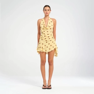 Close-up of the elegant cowl neck design and brown polka dots on this yellow summer dress