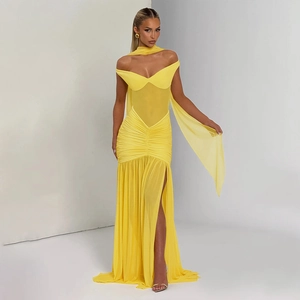 Detailed view of bright yellow mesh dress featuring ruched waist and high side slit