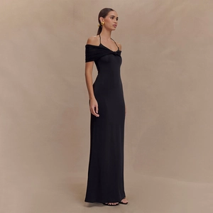 Detail of elegant black off-shoulder mesh dress with crisscross neck and slim fit silhouette