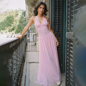 Detailed view of the sheer pleated pink halter dress featuring a structured corset waist