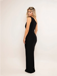 Detail of elegant black one-shoulder maxi dress with ruched bodycon fit and floor-length hem