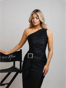 Detail of black one-shoulder dress with side ruching and crystal buckle embellishment