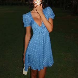 Blue polka dot mini dress with deep V-neck and puff sleeves for summer fashion